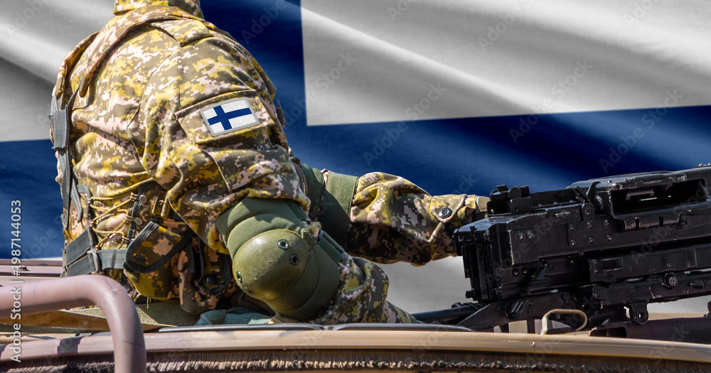 Obraz premium Finland flag with soldier at machinegun turret