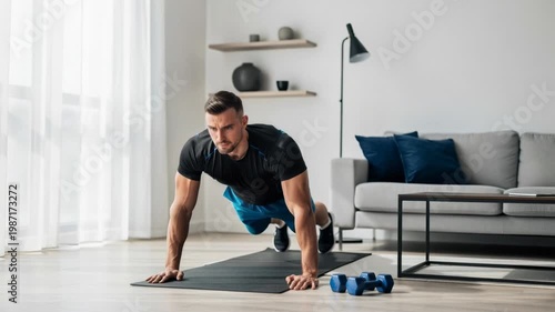 Fit man doing push ups on yoga mat in modern living room focused on home workout and fitness