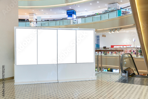Blank multi LED screen TV mockup near escalator in shopping mall interior