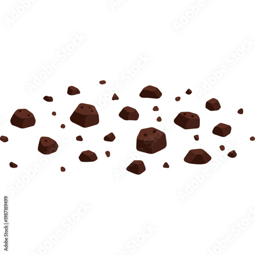 Chunks of chocolate are scattered across a surface in a kitchen.