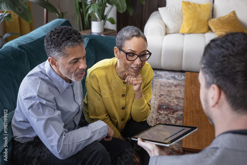 Senior couple looking at an investment plan with financial advisor