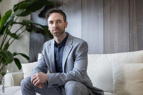 Businessman Exuding Confidence While Resting on Sofa