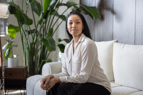 Businesswoman Woman Sitting Gracefully on Sofa with Confident Look