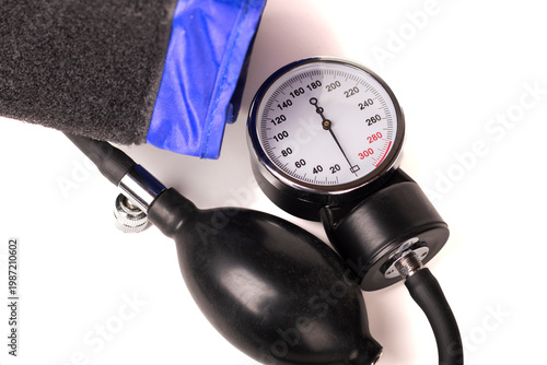 Medical equipment for measuring blood pressure with a gauge and cuff on a white background
