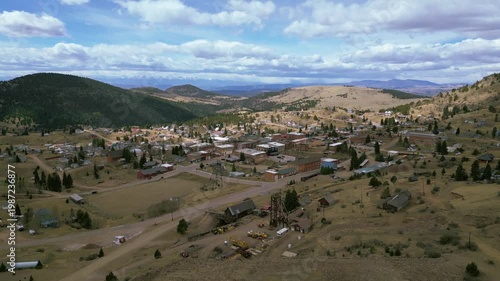 Rural colorado mountain town with clouds and dry grass land 