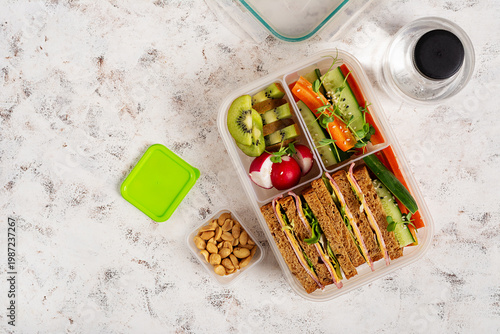 Meal prep lunch with balanced food in container on light background