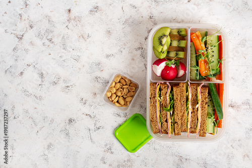 School or office lunchbox with healthy snacks and sandwich
