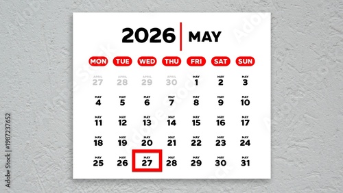 The date May 27th marked with a red cursor on a wall calendar 2026