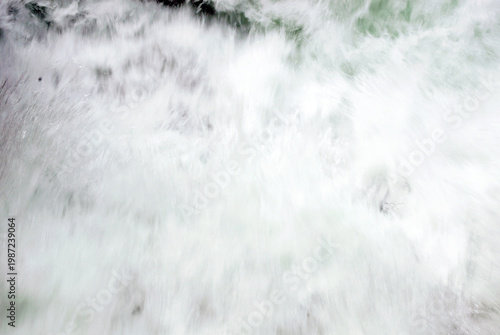 Photography Background of defocuses powerful white exploding water rushing down a channel