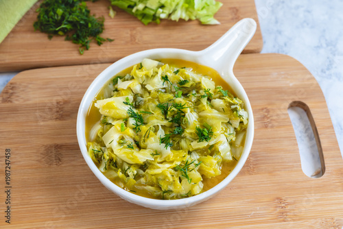 Stewed young cabbage with butter and dill