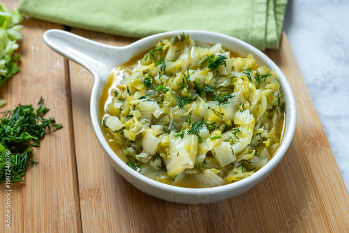 Stewed young cabbage with butter and dill