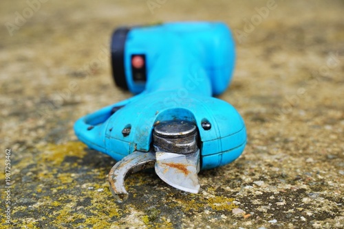 used professional electric cordless pruning shear, a modern agricultural tool designed to make branch cutting more efficient