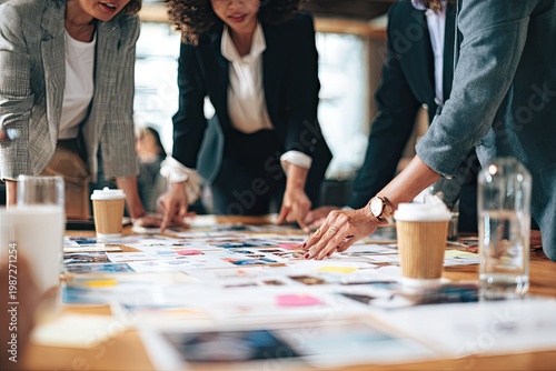 Diverse team collaborating on a project spread across a table