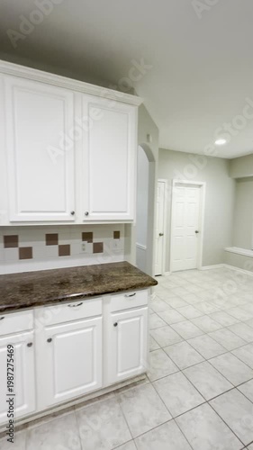 Country home empty vacant kitchen with white cabinets and  stainless steel appliances.