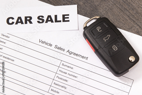Car key, inscription car sale and form of vehicle sales agreement. Sales or purchases new or used vehicle