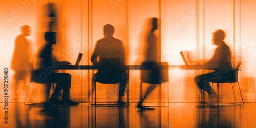 Silhouettes of people working at desks in a bright, blurred office