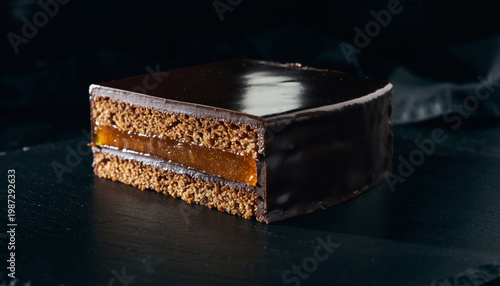 A delicious slice of chocolate cake with caramel filling on a table
