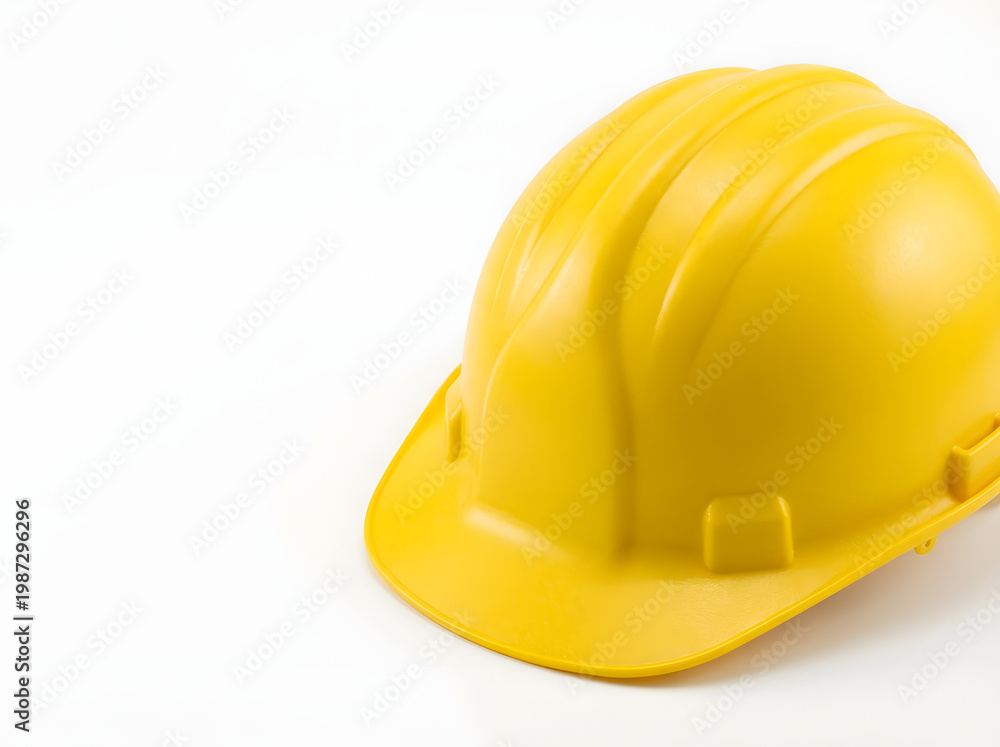 Fototapeta premium Bright yellow hard hat on white background safety first