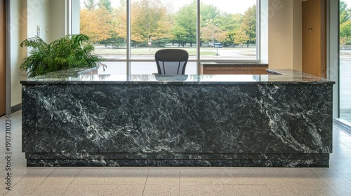 Dark green granite reception desk in modern lobby