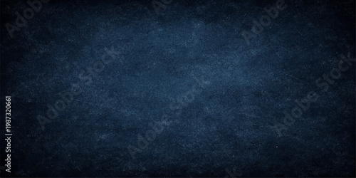 Dark blue grunge textured background with rough vintage wall pattern and chalkboard style surface