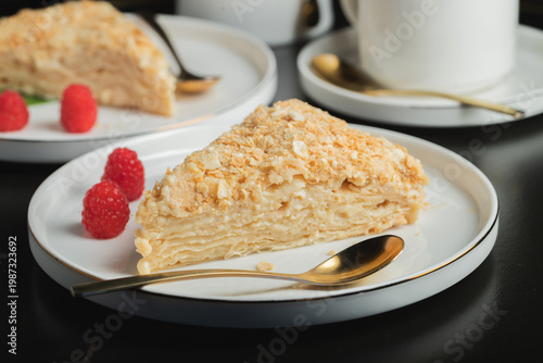 Fotografie Sliced Napoleon cake on a white wooden table. Classic dessert