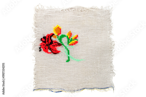 Fotografie Cross-stitch embroidery on light fabric, macro, top view.