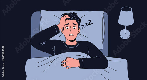 Terrified young man waking up from a nightmare in bed with his hand on his head in a dark room with a lamp.