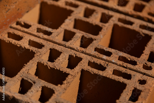 Clay bricks stack construction material close up