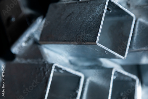 Stacked metal square tubes industrial material close up