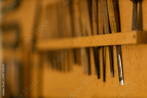 Carpentry tools in wooden rack close up workshop detail