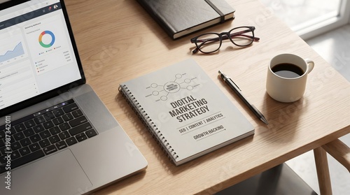 Digital marketing strategy notebook and laptop dashboard on wooden desk