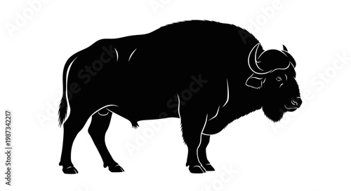 A striking black silhouette of a powerful bison or buffalo standing majestically against a plain white background.