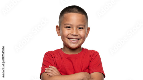Happy young boy with arms crossed smiling.