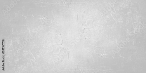 A dark grey brushed metal texture with a grunge pattern on an old rough surface creates a vintage aged backdrop for a textured industrial design. Light gray concrete wall texture background