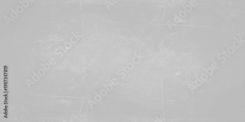 A dark grey brushed metal texture with a grunge pattern on an old rough surface creates a vintage aged backdrop for a textured industrial design. Light gray concrete wall texture background