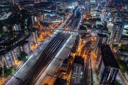 Illuminated railway lines weave through a bustling city at night