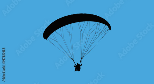 Silhouette Of Person Paragliding Against A Clear Blue Sky