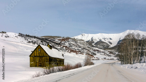 High Elevation Mountain Snowpack and Remote Wood Barn in Winter
