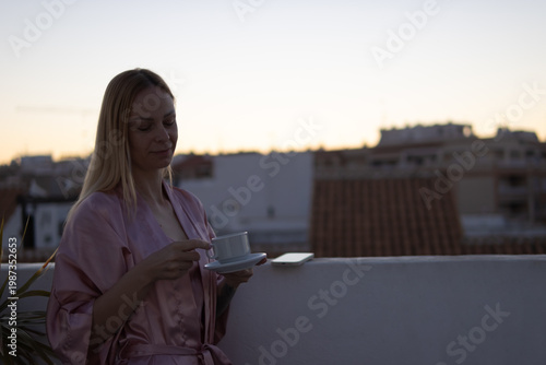 Bild auf Leinwand Woman enjoying morning coffee on an urban rooftop, embracing self-care and relax