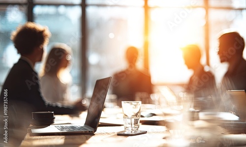 Colleagues in a sunlit room, gathered around a table