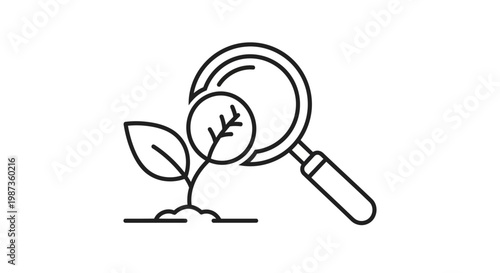 A magnifying glass examines a small plant.