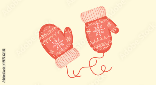 Pair of cozy red winter mittens decorated with white snowflake patterns and connected by a thin string for cold weather.