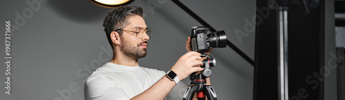 Obraz na płótnie Professional photographer captures moments in a studio setup with a camera and t