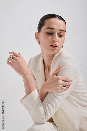 Canvas Print Glamorous woman showcasing modern elegance in chic white suit and stylish access