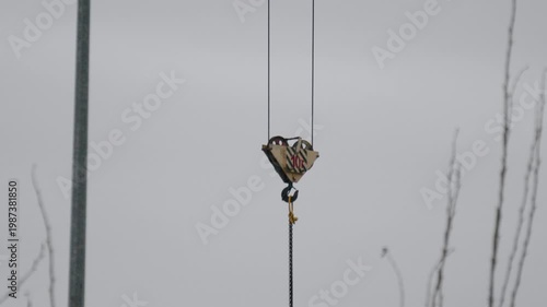 Industrial crane imagery. Construction environment with muted tones highlighting structural elements and mechanical forms throughout scene