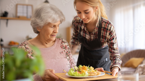 Elderly woman being served healthy meal by caregiver, concept of senior care, nutrition and wellbeing