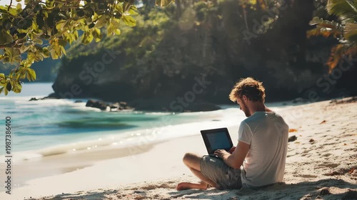 Working on a laptop while sitting on the beach near the water in a tropical location during the day