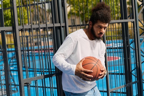 Photography Young man prepares for a thrilling basketball game at an outdoor court
