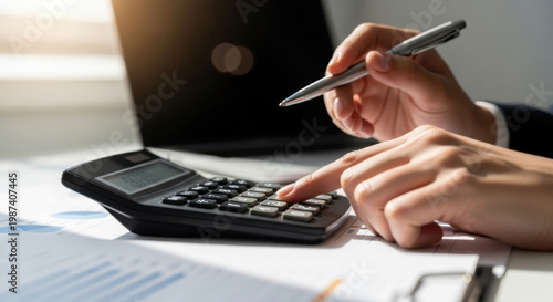 Business professional using calculator and laptop for budget planning, tax calculation and financial analysis, concept of accounting management and cash flow control
