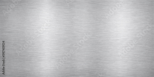 Polished stainless steel plate with a brushed aluminum texture provides a shiny metallic silver surface and industrial grey pattern for a sleek material backdrop